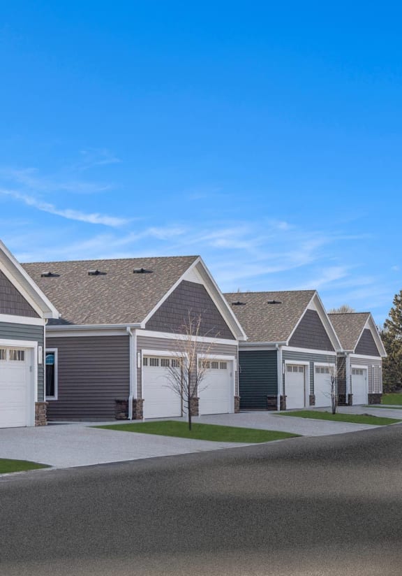 a rendering of a street with houses and a car on the road