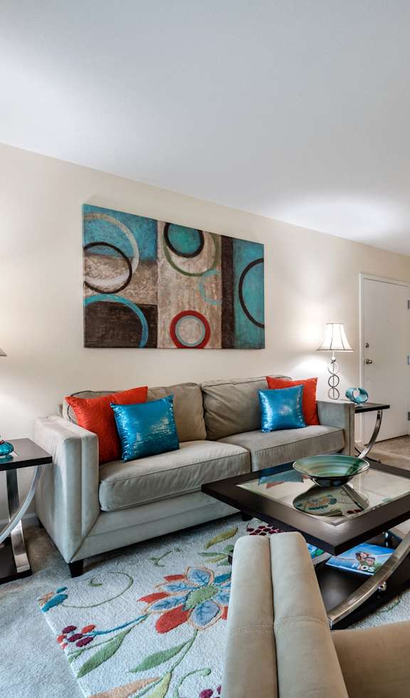 a living room with couches and chairs and a coffee table