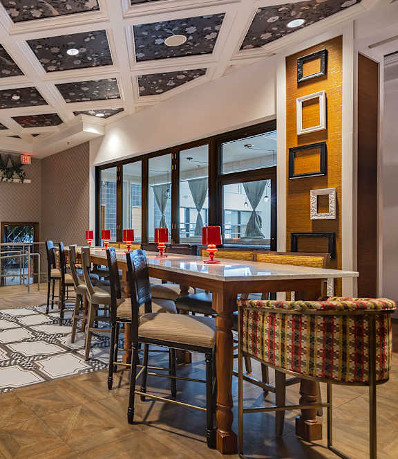 A dining room with a wooden table and chairs.