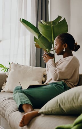 Woman Sitting on a Couch at The Oxford Apartments, Oxon Hill, Maryland 20745