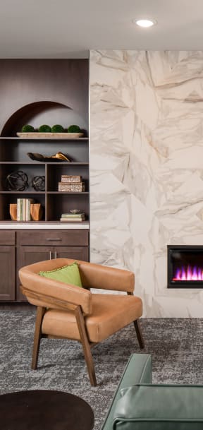 a living room with a fireplace and a table and chairs
