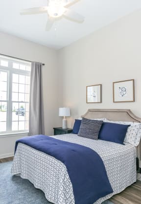 a bedroom with a bed and two night stands at The Station at River Crossing, Macon