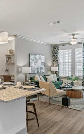 A modern kitchen with a large island and a dining area.