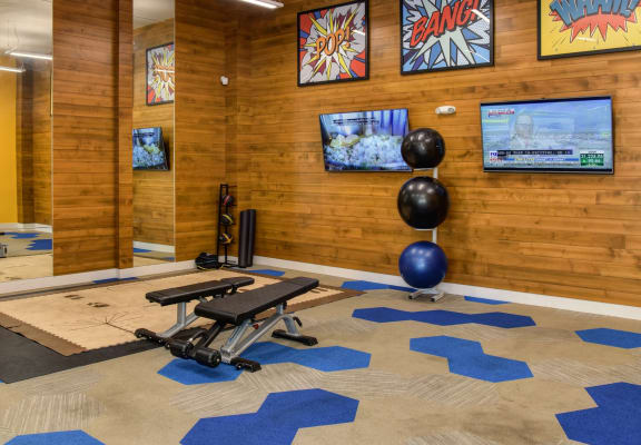 Community Fitness Center Gym with Cardio and Weight Machines, Yoga Balls and Mirrors. The walls are lined with a wooden shiplap look.at Folsom Ranch, Folsom, 95630