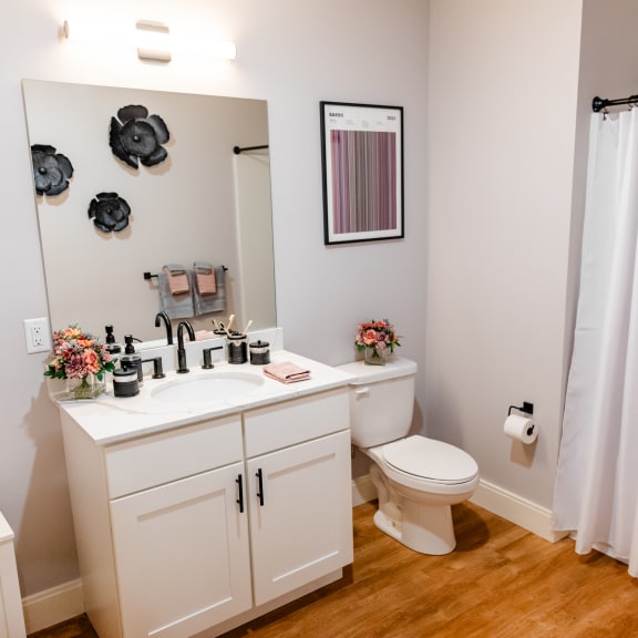 a bathroom with a sink toilet and shower