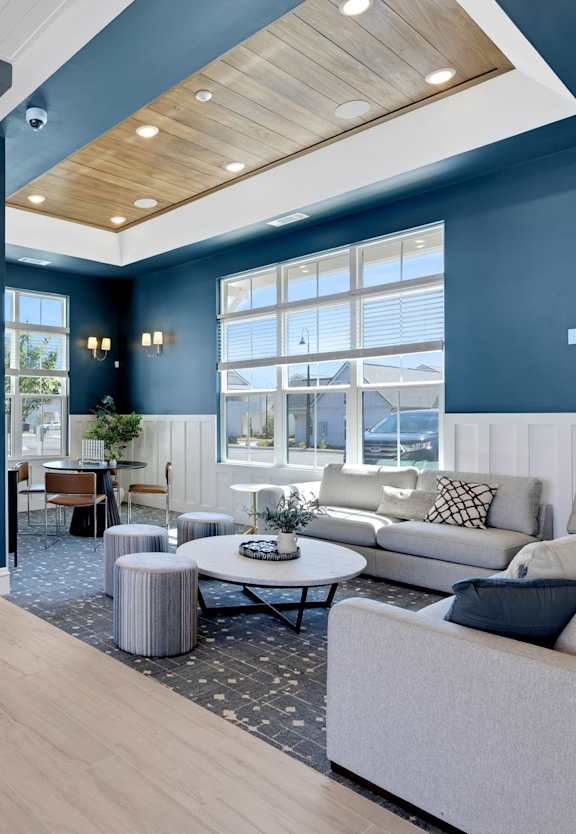 A living room with a grey couch and a coffee table.