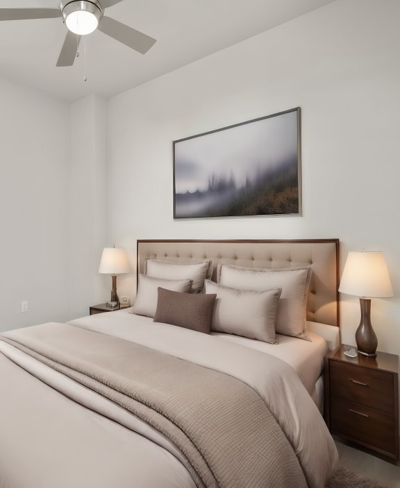 the guest bedroom of a modern home with a bed and a ceiling fan