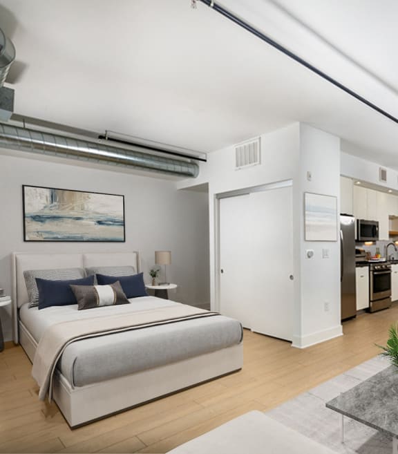 a bedroom with a bed and a living room with a kitchen  at The LC, Los Angeles