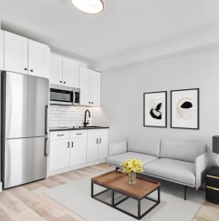 a living room with black furniture and a tv
