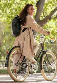 a young woman riding a bike in a park at 605 Concord at Fresh Pond Apartments, Cambridge, MA, 02138