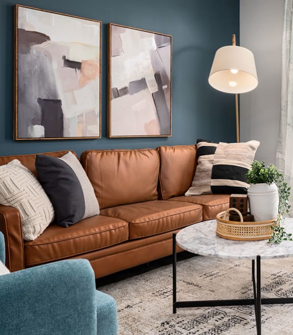 a living room with a brown couch and a door to a patio