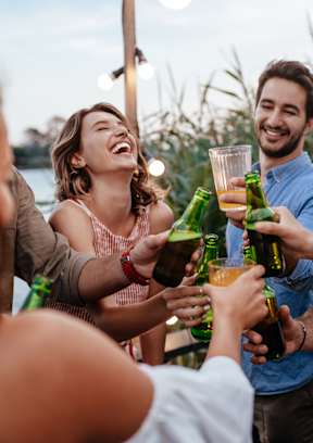 a group of people celebrating with drinks at a party