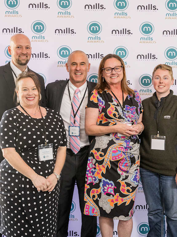 a group of people posing for a photo at an awards ceremony