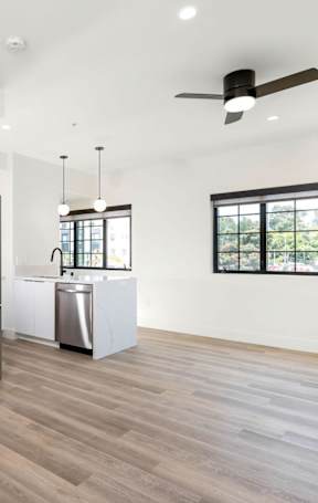 A room with a white door and a glass wall with a view of a city.