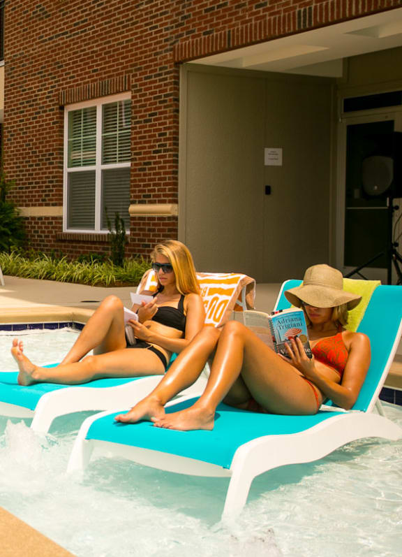 women relaxing by the pool at Greenway at Fisher Park, Greensboro, NC