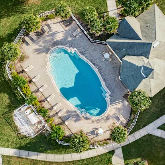 An aerial view of a house with a swimming pool.