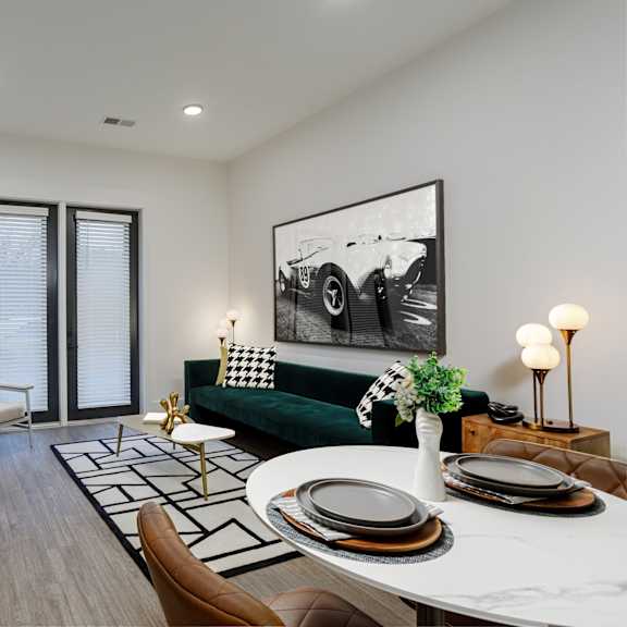 A modern living room with a green couch and a coffee table. at Vintage Edge Nashville Apartments, Tennessee, 37211