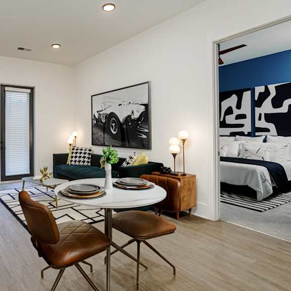 A modern living room with a dining table and chairs. at Vintage Edge Nashville Apartments, Tennessee, 37211