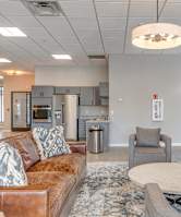 a leather couch with kitchenette and tv
