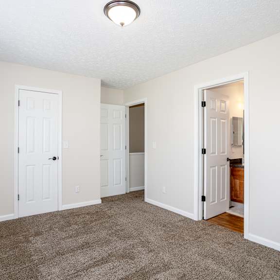 A large swimming pool surrounded by lounge chairs and umbrellas.