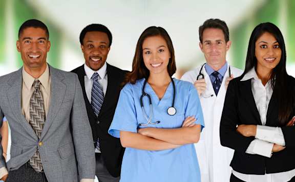 A group of professionals from various fields are standing together.