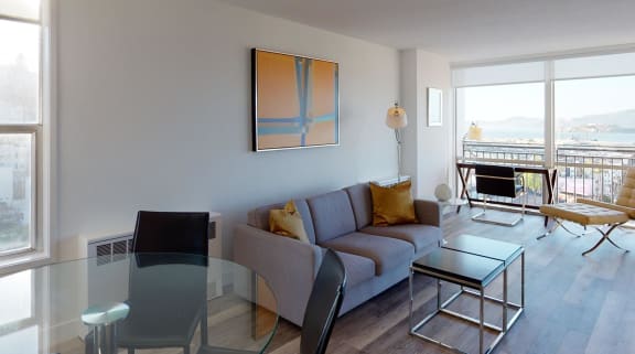 a living room with a glass table and couch