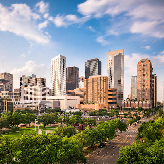 A cityscape with tall buildings and a clear sky.