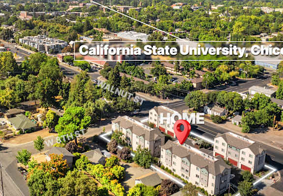 An aerial view of a university campus with a red marker indicating a specific location.