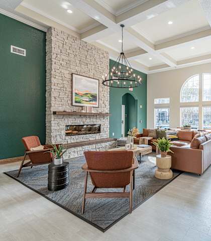 a living room with a fireplace and a table and chairs