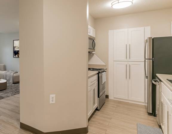 A kitchen and living room with a dining table and chairs at Mill House Apartments, Greenfield, MA, 01301