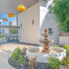a fountain in a courtyard in front of a building at The Flats on Addison, Sherman Oaks