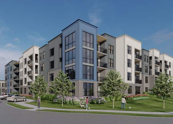 A modern apartment complex with people walking on the sidewalk.