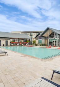 the resort style pool with lounge chairs at our apartments
