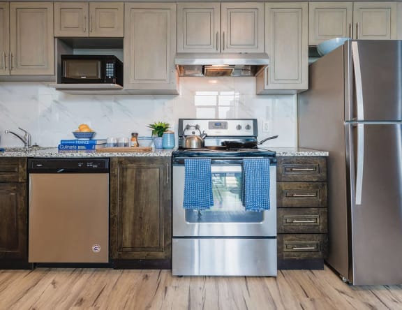 a kitchen with stainless steel appliances and wooden cabinets