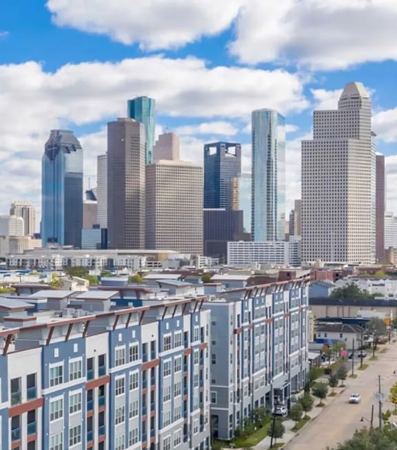 an aerial view of an apartment building with a city in the background