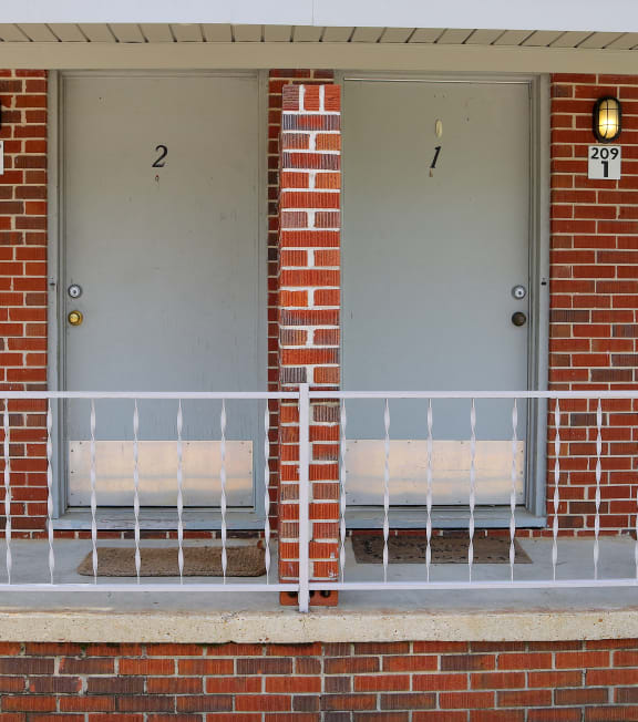 a brick building with two doors and a ramp