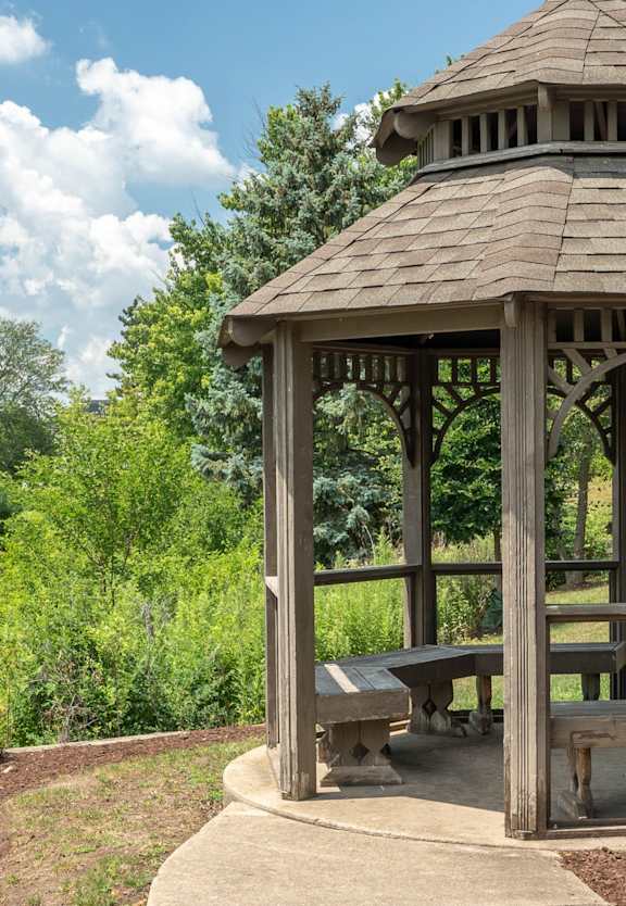 A patio with a fire pit and chairs.