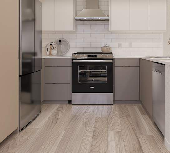 A modern kitchen with stainless steel appliances and white cabinetry.