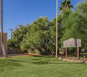 A sign for Cambell Ranch stands in a grassy field.