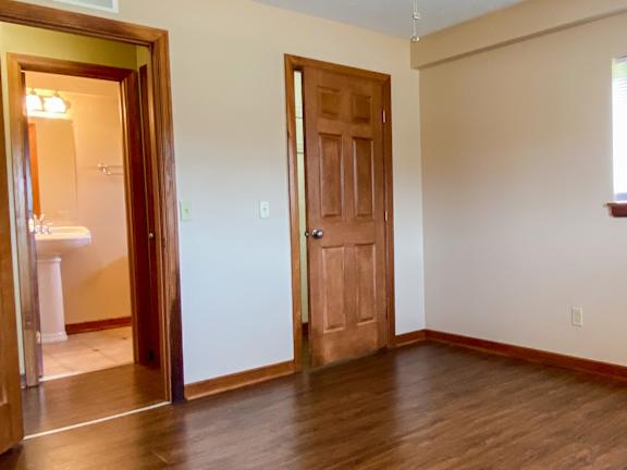 A room with a ceiling fan and wooden floors. at Hallwood Manor Apartments, Ohio, 44060