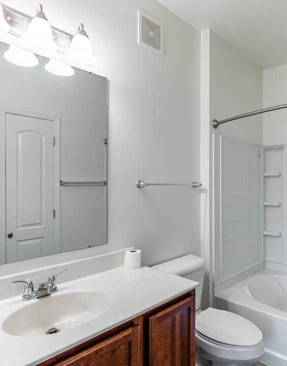 A white bathroom with a sink, toilet, and bathtub.