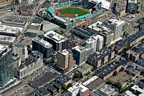 A cityscape with a large building in the center and a river running through it.