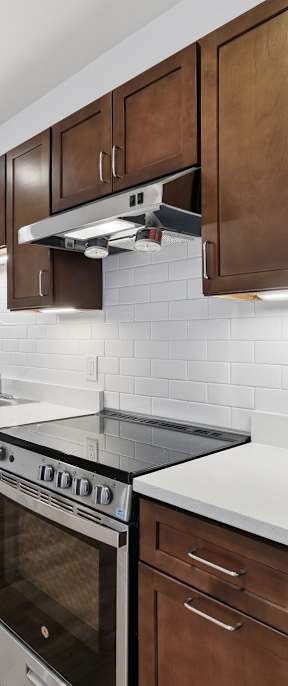 A kitchen with wooden cabinets and stainless steel appliances.