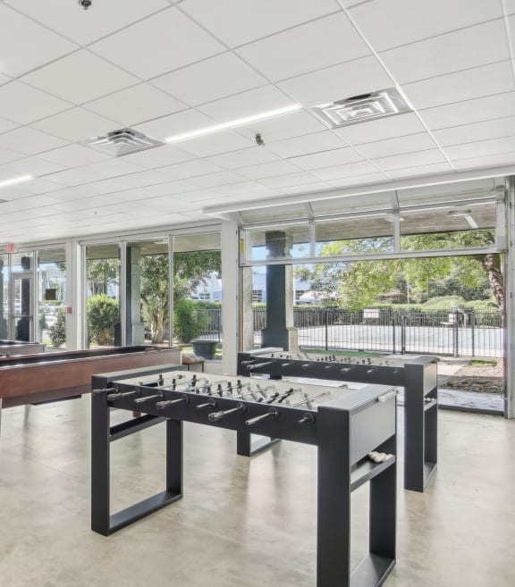 a game room with a foosball table and ping pong