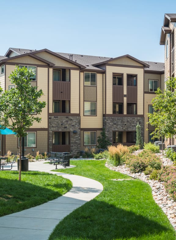 a living room with a couch and coffee table in front of a large window with a pool at Estate at Woodmen Ridge, Colorado Springs