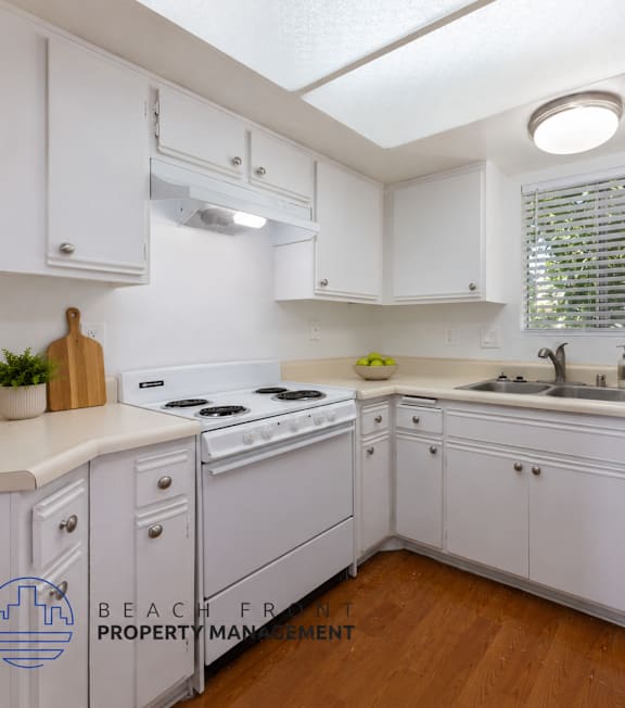 A well-lit, modern kitchen and living room with a dining area.