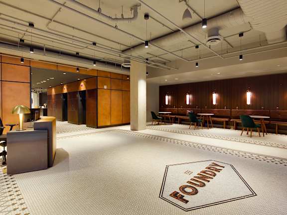 A room with a white floor and a logo that says "FOUNDRY" on it.
