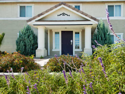 A house with a black front door and a small porch.