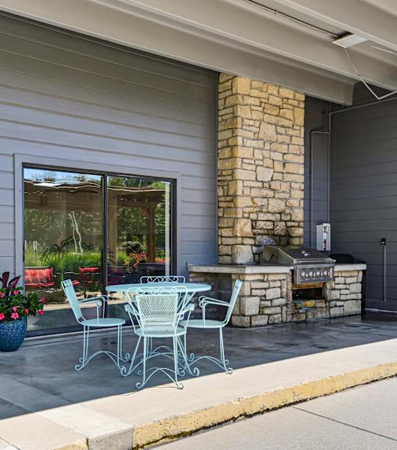 photo of a stone outdoor bbq with bistro seating