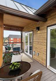 A balcony with a table and chairs is shown.